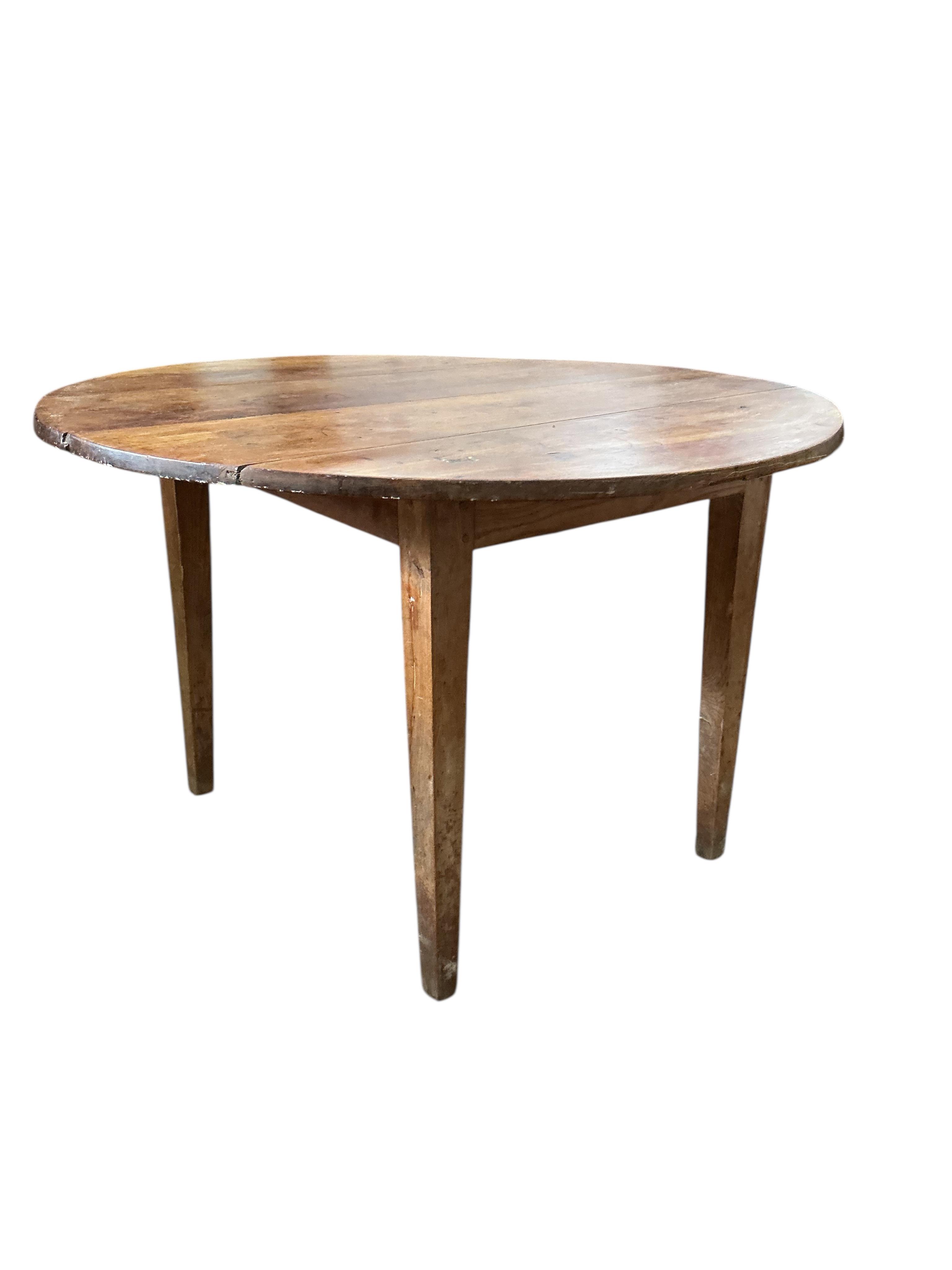 A 19th century French circular cherry kitchen table, diameter 113cm, height 74cm